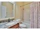 Clean bathroom featuring tiled shower, granite vanity top, and modern fixtures at 8704 Winsome Way, Land O Lakes, FL 34637