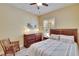 Comfortable bedroom with wood furniture, neutral colors, and a window with wood shutters at 8704 Winsome Way, Land O Lakes, FL 34637