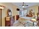 Bedroom with a ceiling fan, hard wood floors, dresser, and a window with shutters at 8704 Winsome Way, Land O Lakes, FL 34637