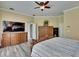 Primary bedroom suite with natural light and dresser with tv at 8704 Winsome Way, Land O Lakes, FL 34637