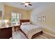 Cozy bedroom with a wood bed frame and a window with wood blinds at 8704 Winsome Way, Land O Lakes, FL 34637