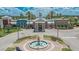 Beautiful clubhouse entrance with a fountain and inviting landscaping; enhancing the community's appeal at 8704 Winsome Way, Land O Lakes, FL 34637