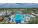 Inviting community pool with palm trees and plenty of lounge chairs, ideal for relaxation and summer fun at 8704 Winsome Way, Land O Lakes, FL 34637