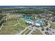 Stunning aerial view of a community pool, tennis courts, and green space, offering resort-style amenities at 8704 Winsome Way, Land O Lakes, FL 34637