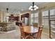 Dining area with light fixture above table and near window with shutters at 8704 Winsome Way, Land O Lakes, FL 34637