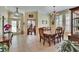 Well-lit dining room features tile floors, an elegant chandelier, and views into the office at 8704 Winsome Way, Land O Lakes, FL 34637
