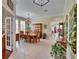 Spacious dining room with tile flooring, large windows, an elegant chandelier, and ample natural light at 8704 Winsome Way, Land O Lakes, FL 34637