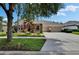 Beautiful single-Gathering home with a well-manicured lawn, three-car garage, and inviting stone entryway at 8704 Winsome Way, Land O Lakes, FL 34637