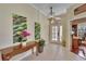 Inviting home foyer featuring tile flooring, artwork, a console table, and an arched entryway to the office at 8704 Winsome Way, Land O Lakes, FL 34637