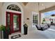 Inviting porch with a front door, a cushioned swing, and a lovely view of the surroundings at 8704 Winsome Way, Land O Lakes, FL 34637