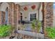 Charming porch featuring stone columns, hanging flower baskets, and a cozy space to relax at 8704 Winsome Way, Land O Lakes, FL 34637