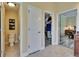 Hallway leading to a bathroom, walk-in closet, and bedroom with tile flooring at 8704 Winsome Way, Land O Lakes, FL 34637