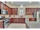 Updated kitchen features stainless steel appliances, a window over the sink, and granite counters at 8704 Winsome Way, Land O Lakes, FL 34637
