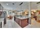 Tile-floored kitchen featuring bar-top seating at the island, and views into the Gathering room at 8704 Winsome Way, Land O Lakes, FL 34637