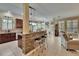 Open kitchen with island seating, tile floors, and a view into the living room at 8704 Winsome Way, Land O Lakes, FL 34637