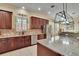 Kitchen features granite countertops, stainless steel appliances, and a window over the sink at 8704 Winsome Way, Land O Lakes, FL 34637