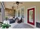 Relaxing outdoor screened-in lanai with stone wall and comfortable seating area at 8704 Winsome Way, Land O Lakes, FL 34637