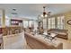 Open-concept living room, dining area and kitchen, featuring tile floors and neutral decor at 8704 Winsome Way, Land O Lakes, FL 34637