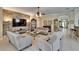 Large living room with stone accent wall, view to kitchen and dining area and featuring tile floors and neutral decor at 8704 Winsome Way, Land O Lakes, FL 34637