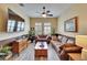 Living room featuring two sofas, a coffee table, hardwood floors, and a large TV at 8704 Winsome Way, Land O Lakes, FL 34637