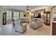 Spacious living room with stone accent wall, tile flooring, and neutral furniture at 8704 Winsome Way, Land O Lakes, FL 34637