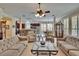 Large living room with view of kitchen and dining area, and featuring tile floors and neutral decor at 8704 Winsome Way, Land O Lakes, FL 34637