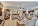 Spacious living room that opens to the kitchen and dining area and features tile floors and neutral decor at 8704 Winsome Way, Land O Lakes, FL 34637