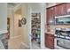 Walk-in pantry adjacent to the kitchen has lots of shelving for food storage at 8704 Winsome Way, Land O Lakes, FL 34637