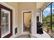 View of the powder room through the interior porch with grill, rug and view of the backyard at 8704 Winsome Way, Land O Lakes, FL 34637