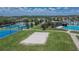 Aerial view of tennis courts, a volleyball court, and community pool; perfect for active living in this community at 8704 Winsome Way, Land O Lakes, FL 34637