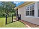 Exterior corner of the house showing a fenced yard with decorative stones and well-maintained landscaping at 8704 Winsome Way, Land O Lakes, FL 34637
