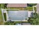 Aerial view showing the home's roof, backyard with patio, and proximity to neighboring houses at 8717 Persea Ct, Trinity, FL 34655