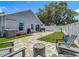 Wide backyard featuring artificial turf, a paver patio, outdoor seating, and a grill, perfect for outdoor living at 8717 Persea Ct, Trinity, FL 34655