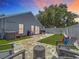 Beautiful backyard area with patio, artificial grass, and white privacy fence, perfect for outdoor entertaining at 8717 Persea Ct, Trinity, FL 34655