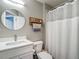Bathroom featuring a vanity, toilet, and shower with a neutral color palette at 8717 Persea Ct, Trinity, FL 34655