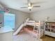 Bedroom with bunkbeds, a window, a bookcase, and a ceiling fan at 8717 Persea Ct, Trinity, FL 34655