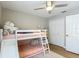 A full view of the bedroom showing a double bunk bed and a window and a ceiling fan at 8717 Persea Ct, Trinity, FL 34655
