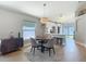 Cozy dining area with a round table, four chairs, and a modern pendant light fixture at 8717 Persea Ct, Trinity, FL 34655