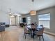 Bright dining area open to the living space, featuring a round table and a modern light fixture at 8717 Persea Ct, Trinity, FL 34655
