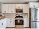 Kitchen featuring stainless steel appliances, white cabinetry, and a modern design at 8717 Persea Ct, Trinity, FL 34655
