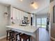 Well-lit kitchen showcases white cabinetry, stainless steel appliances, and a breakfast bar with seating at 8717 Persea Ct, Trinity, FL 34655