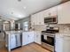 Kitchen with stainless appliances and view to Gathering room at 8717 Persea Ct, Trinity, FL 34655