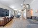 Open-concept living room featuring wood-look floors, neutral walls, and a comfortable gray sofa at 8717 Persea Ct, Trinity, FL 34655