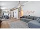 Bright living room showcasing wood-look floors and a large gray sectional sofa at 8717 Persea Ct, Trinity, FL 34655