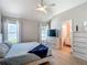 Primary bedroom featuring natural light, ensuite bath access, and hardwood flooring at 8717 Persea Ct, Trinity, FL 34655
