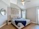 Primary bedroom featuring a decorative wall, hardwood floors, and natural light at 8717 Persea Ct, Trinity, FL 34655