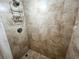 Bathroom showcasing a modern tiled shower with mounted shelving at 880 Mandalay Ave # N311, Clearwater Beach, FL 33767