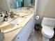 Bathroom features a vanity with white cabinet and marbled countertop at 880 Mandalay Ave # N311, Clearwater Beach, FL 33767