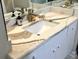 Bathroom vanity with sleek white cabinets, stone countertop, and modern fixtures and finishes at 880 Mandalay Ave # N311, Clearwater Beach, FL 33767