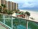 Stunning view of the beach from the condo's balcony, overlooking the pool and shuffleboard at 880 Mandalay Ave # N311, Clearwater Beach, FL 33767